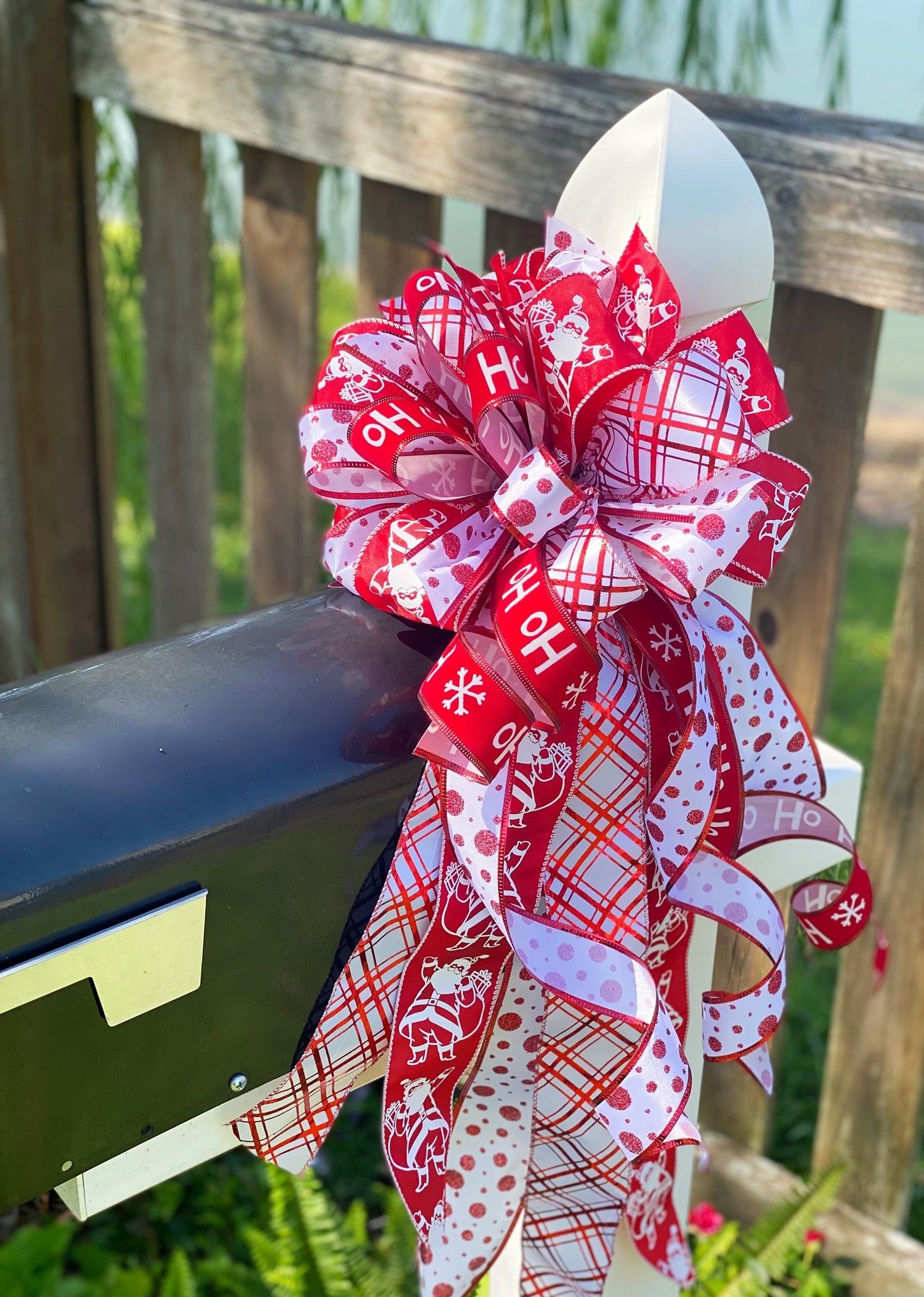 Christmas Bow in Red and White Featuring Santa Claus' and HoHoHo’s. Perfect for Mailbox, Door, and Wreath.