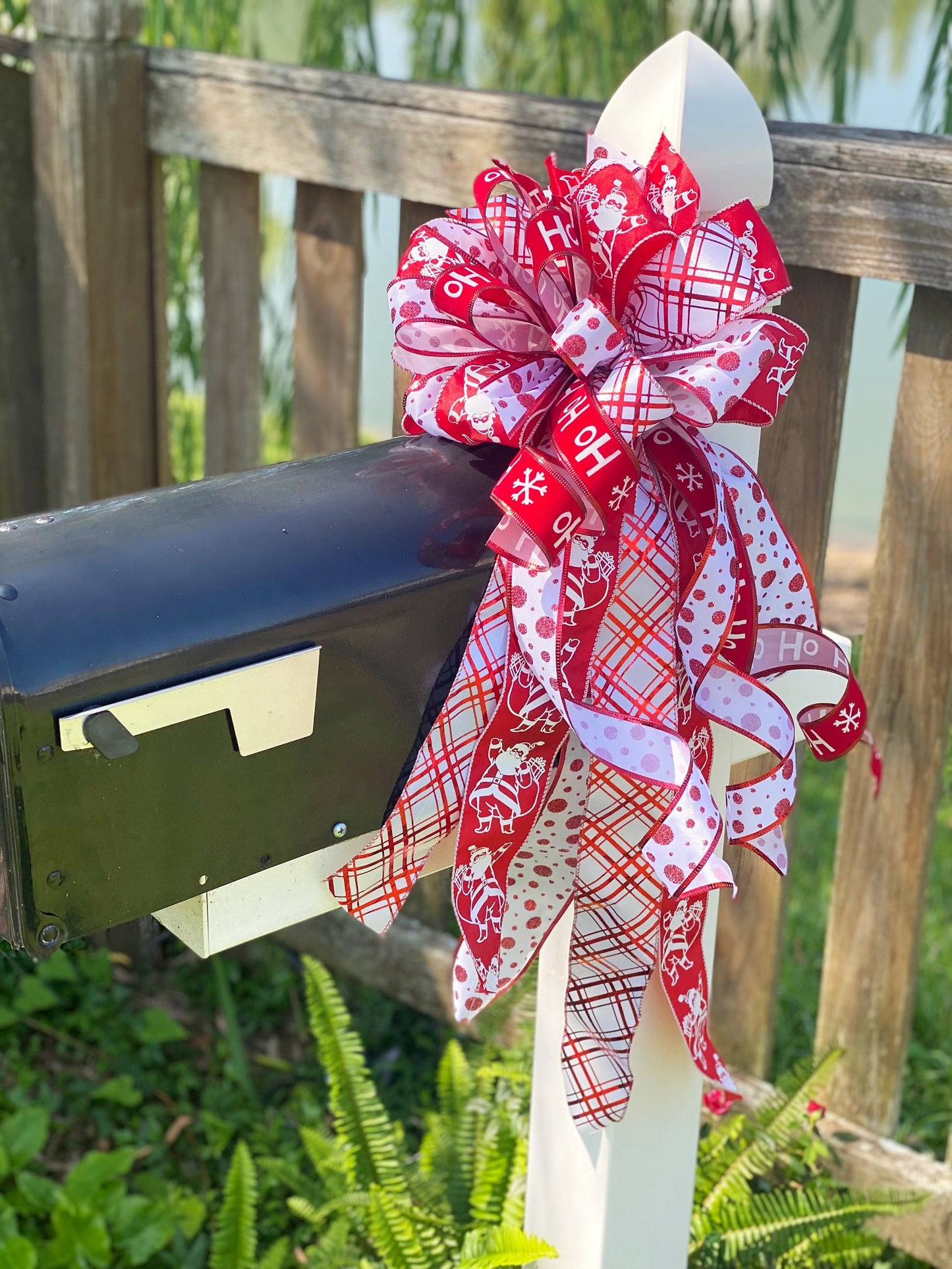 Christmas Bow in Red and White Featuring Santa Claus' and HoHoHo’s. Perfect for Mailbox, Door, and Wreath.