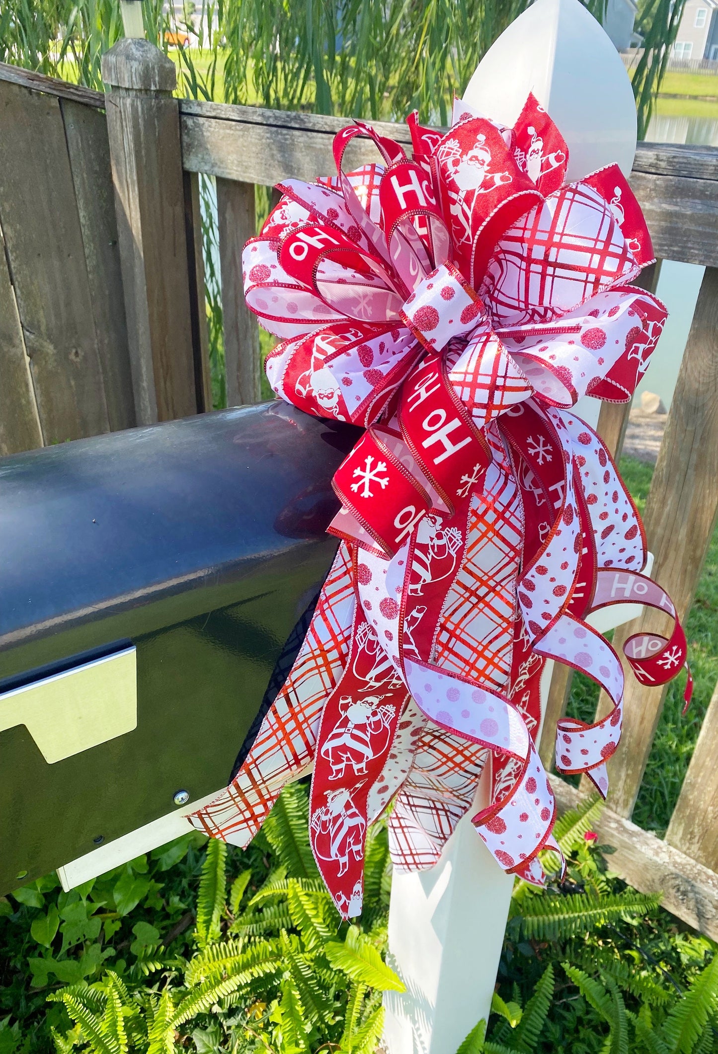 Christmas Bow in Red and White Featuring Santa Claus' and HoHoHo’s. Perfect for Mailbox, Door, and Wreath.