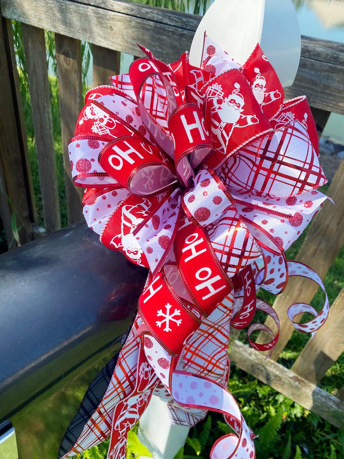 Christmas Bow in Red and White Featuring Santa Claus' and HoHoHo’s. Perfect for Mailbox, Door, and Wreath.