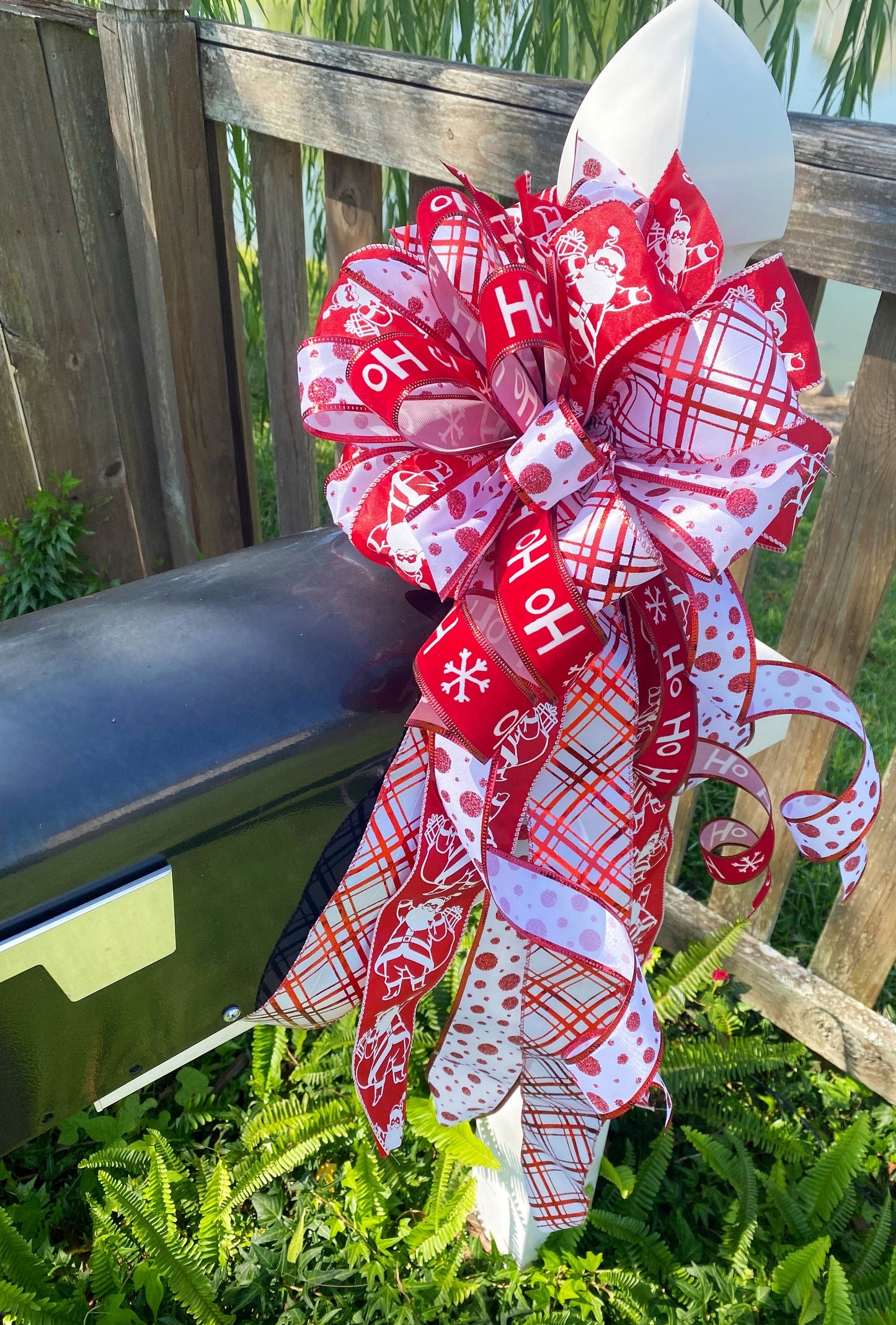 Christmas Bow in Red and White Featuring Santa Claus' and HoHoHo’s. Perfect for Mailbox, Door, and Wreath.