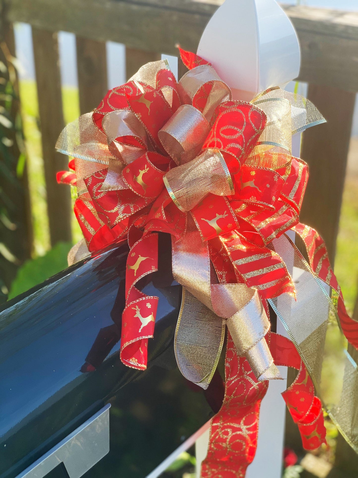 Christmas Bow in Red and Gold Featuring Gold Reindeer Ribbon. Perfect for Mailbox, Door, or Wreath.