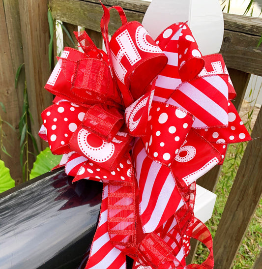 Christmas Bow in Red and White Featuring Santa Claus' Iconic HO HO HO Ribbon. Perfect for Mailbox, Door, and Wreath.