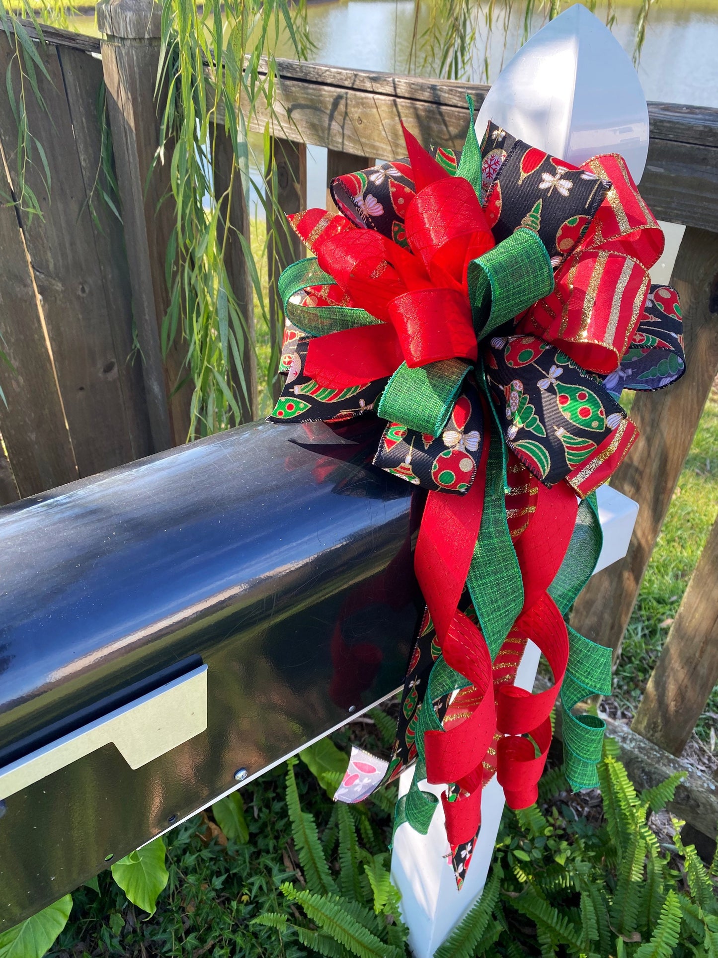 Christmas Bow in Red, Black, and Green Featuring Colorful Ornament Ribbon. Perfect for Mailbox, Door, and Wreath.